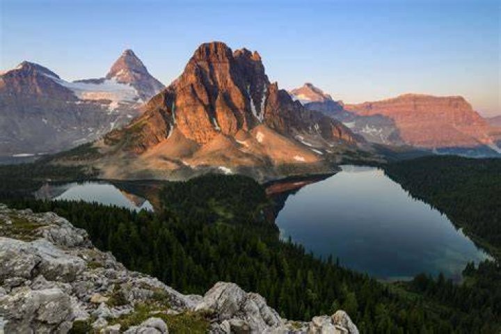 High point of a mountain or a corporate stock
